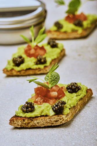 TOMATO AND AVOCADO TOAST TOPPED WITH CELESTE CAVIAR